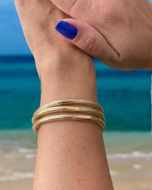 Polished 18k gold twist bangles — Sierra Jewelry